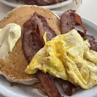 2 huge fluffy pancakes, 2 eggs , 4 thick slices of bacon $10 Hot Chocolate $2