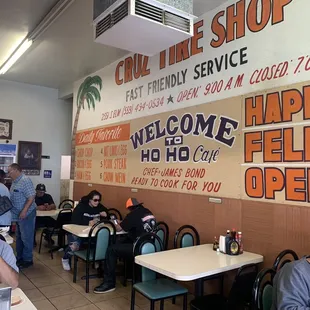 people sitting at tables in a restaurant