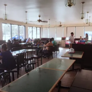 a group of people sitting at tables in a restaurant
