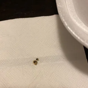 a close up of a piece of toilet paper with a hole in it