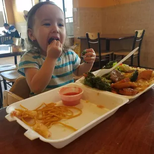 Child chowing down on some chow mein.