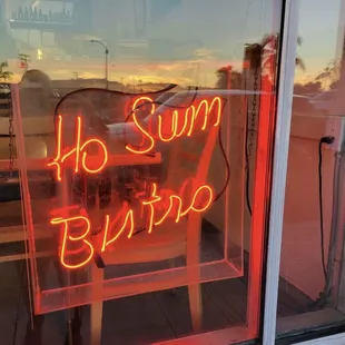 a neon sign in a window