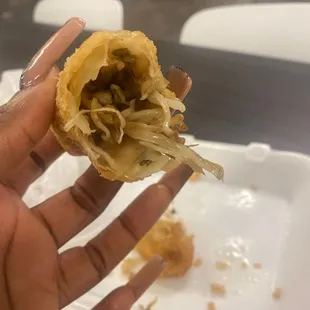 a hand holding a half eaten pastry
