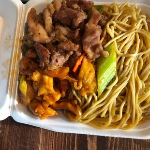 a plate of noodles and meat