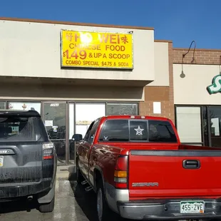 two trucks parked in front of the building