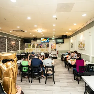 people sitting at tables in a restaurant