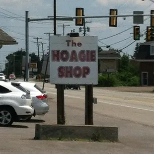 a car parked in front of a hoagie shop