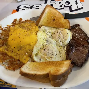 Steak and eggs plus hash browns with cheese.
