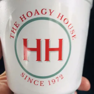 a hand holding a cup of coffee