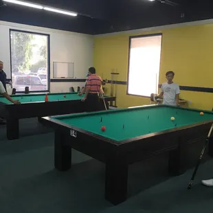 a group of people playing pool