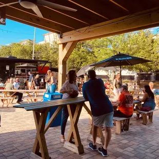 a group of people sitting at picnic tables