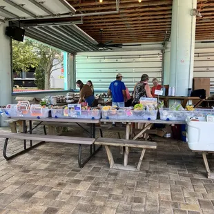 two people standing at a picnic table