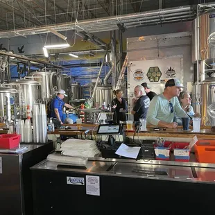 a group of people in a brewery