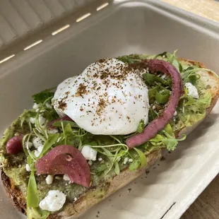 a sandwich with an egg on top