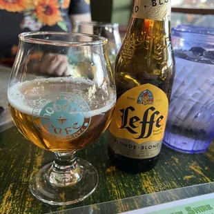 a glass of beer and a bottle of beer