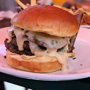 Hobnobber Burger. Three 4-oz smashed beef patties, caramelized onion jam, 420 beer cheese, dill pickles, Alon&apos;s brioche buns. $18.45.