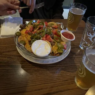 a plate of nachos and beer