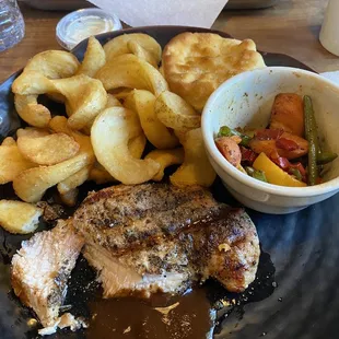 Pork chop with side of fries and sautéed veggies