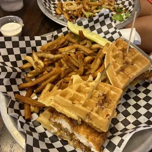 Chicken and waffle sandwich with fries on the side