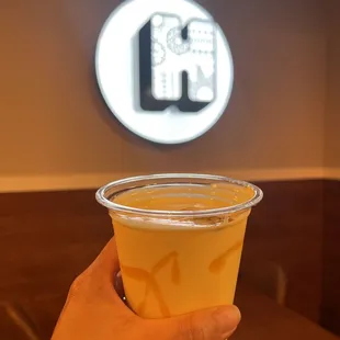 a hand holding a plastic cup