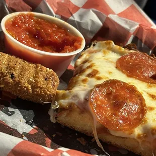 Pepperoni, pizza, and mozzarella sticks with marinara sauce