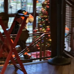 a man sitting on a chair in front of a christmas tree