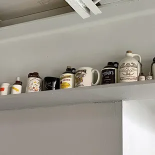 a shelf of coffee mugs
