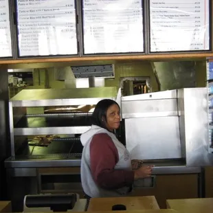 a woman standing in front of a counter