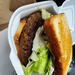 a burger in a styrofoam container