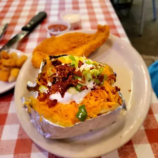 Southern fried Catfish with a salad and baked potato all the way.