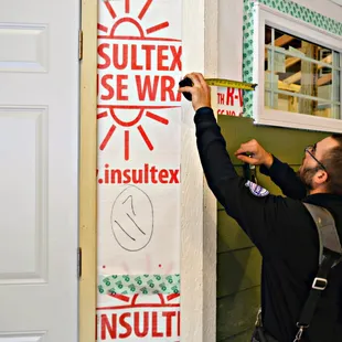 a man measuring a wall