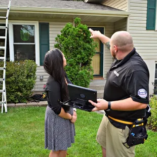 a man and woman in front of a house