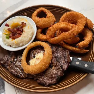 Ribeye with loaded mashed potatoes and onion rings