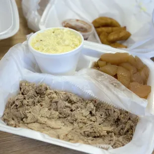 Small pork bbq dinner with potato salad, baked apples, and hushpuppies