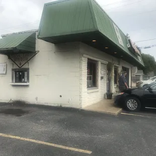 a woman standing outside of a restaurant