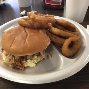 a burger and onion rings on a plate