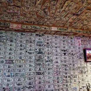 Wall and ceiling filled with signed dollar bills