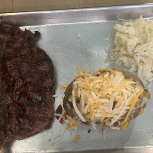 Ribeye steak, fully loaded, baked potato and coleslaw