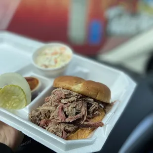 ows a person holding a tray of food