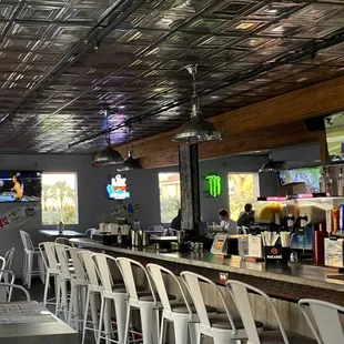 a bar with white chairs