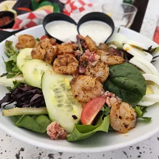 Blackened Shrimp Cobb $18. Brown and wilted lettuce, grey hardboiled egg, and shrimp had translucent parts. Missing guacamole and cheese.