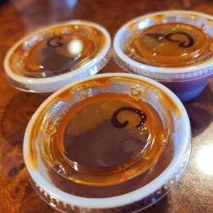 three plastic cups of bbq