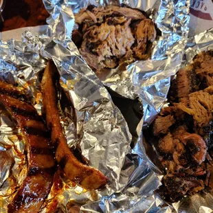 a bbq and ribs wrapped in foil