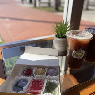 a cup of coffee and a box of jellys