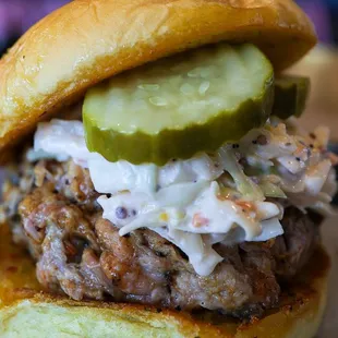 Traditional Pork Sandwich. Pulled Pork topped with Creamy Cole Slaw, Dill Pickles, and Columbus Original Sauce garlic grilled potato roll.
