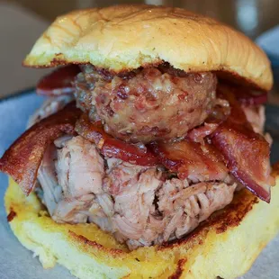 BB Pork Sandwich. Pulled Pork, Bacon Jam, Bacon, and Jamaican Me Crazy Sauce on top of a garlic butter grilled potato roll.