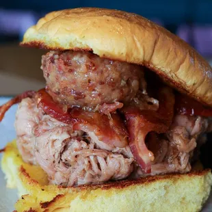 BB Pork Sandwich. Pulled Pork, Bacon Jam, Bacon, and Jamaican Me Crazy Sauce on top of a garlic butter grilled potato roll.
