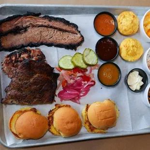 Grazer. Three Meats, Three Buns, Three Sauces, Three Sides, and two corn bread muffins.