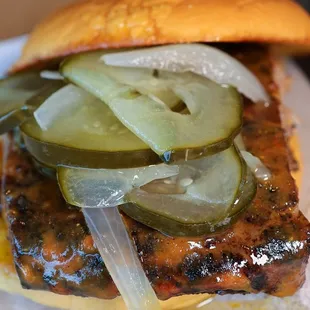 Pig Rib Sandwich. Columbus Original BBQ Sauce, Quarter Rack of Ribs, Bread and Butter Pickles, on top of a garlic butter grilled Potato Bun.