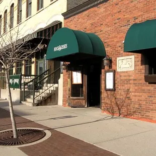 a brick building with a green awning